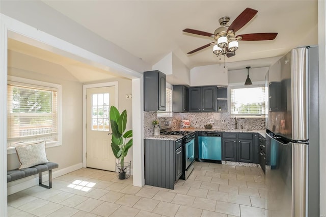 kitchen featuring appliances with stainless steel finishes, gray cabinetry, stone countertops, and ceiling fan