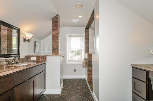 bathroom featuring lofted ceiling, tile patterned floors, and vanity