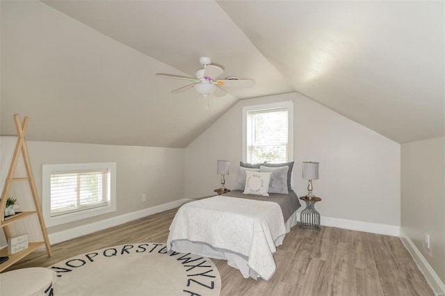 bedroom featuring ceiling fan, light hardwood / wood-style floors, and vaulted ceiling