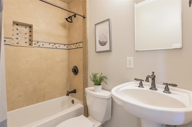 full bathroom featuring toilet, sink, and tiled shower / bath