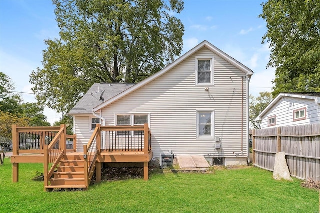 rear view of property with a lawn and a deck