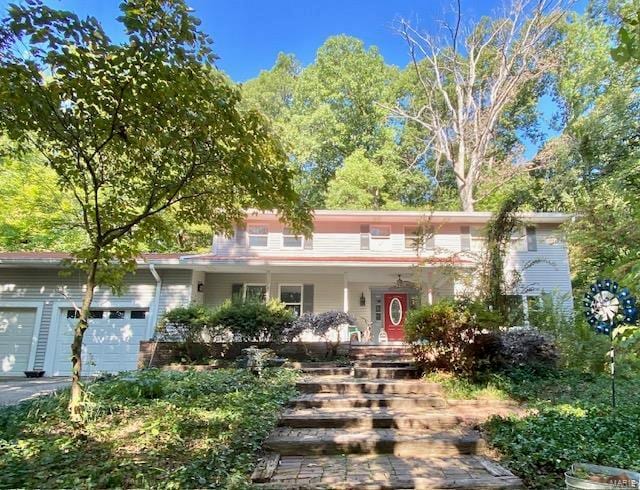 view of front of house featuring covered porch and a garage