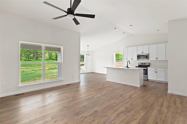 kitchen featuring white cabinets, appliances with stainless steel finishes, plenty of natural light, and ceiling fan