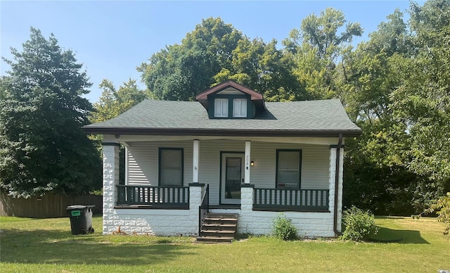 bungalow-style house featuring a porch and a front lawn