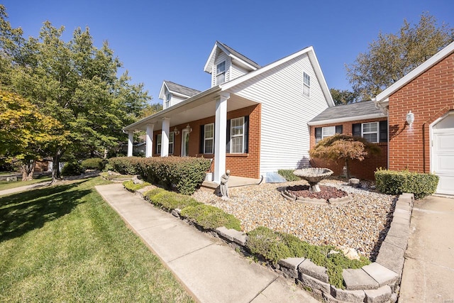 view of home's exterior featuring a porch and a yard