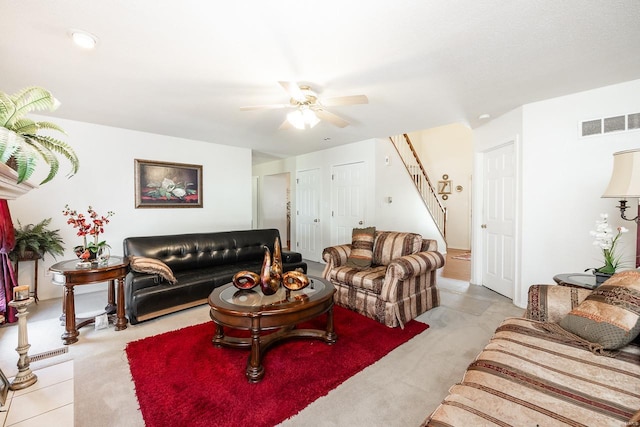 carpeted living room featuring ceiling fan