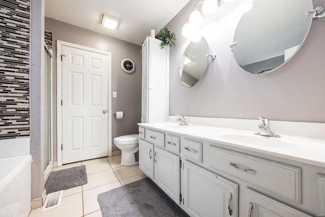 full bathroom featuring vanity, shower with separate bathtub, toilet, and tile patterned flooring