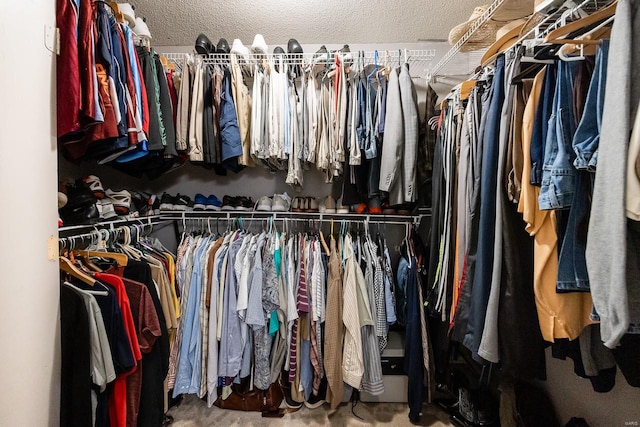 walk in closet featuring carpet