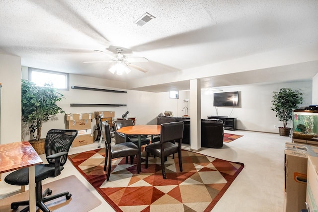 dining space featuring a textured ceiling and ceiling fan