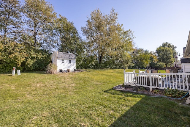 view of yard featuring a storage shed and a deck