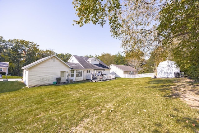 back of house with a lawn