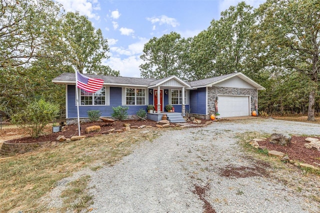 single story home featuring a porch and a garage