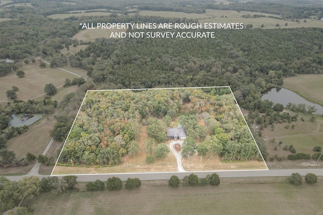 birds eye view of property featuring a rural view and a water view