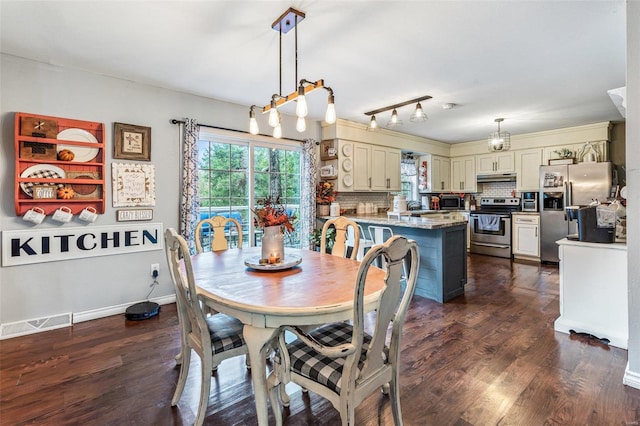 dining space with dark hardwood / wood-style floors