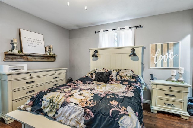 bedroom with dark hardwood / wood-style flooring