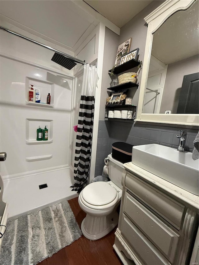 bathroom with tasteful backsplash, walk in shower, vanity, hardwood / wood-style flooring, and toilet