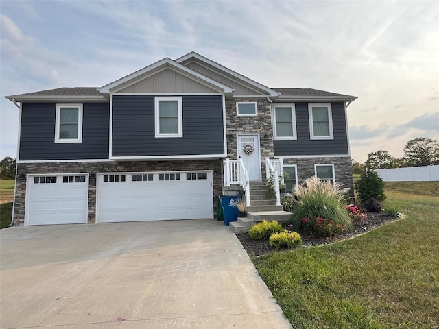 view of front of home with a garage and a front lawn