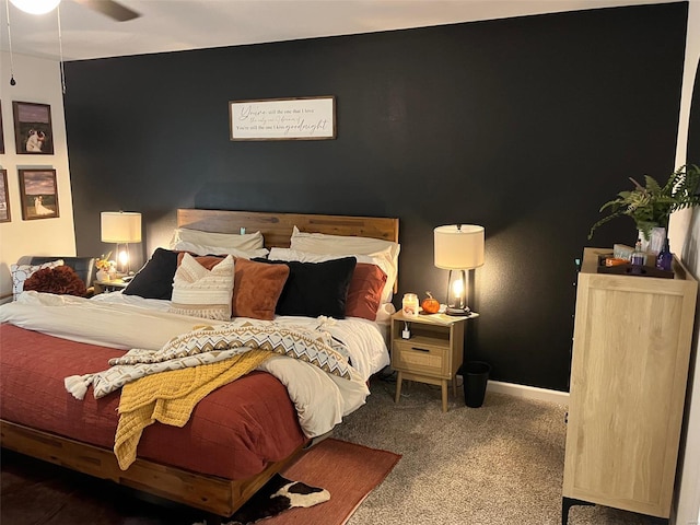 bedroom featuring ceiling fan and carpet