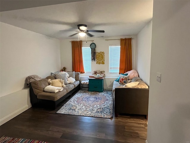 living room with ceiling fan and dark hardwood / wood-style floors