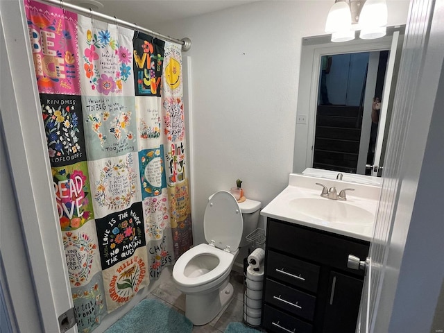 bathroom with vanity, toilet, a shower with curtain, and tile patterned floors