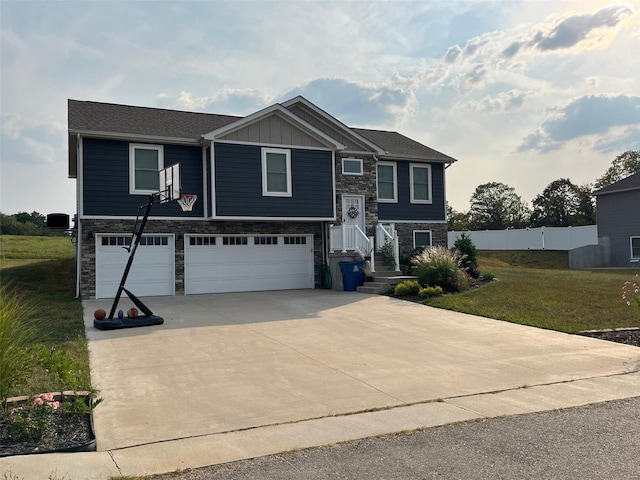 split foyer home featuring a garage and a front yard