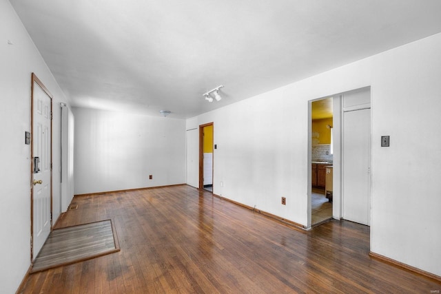 unfurnished room with dark hardwood / wood-style floors