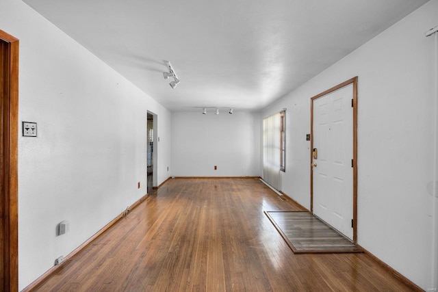 entrance foyer with hardwood / wood-style floors and track lighting