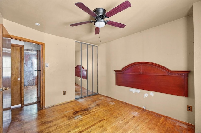 interior space featuring a closet, wood-type flooring, and ceiling fan