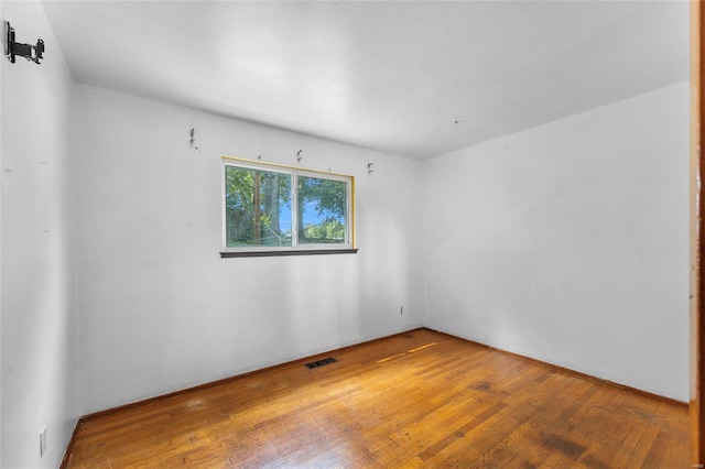 spare room with hardwood / wood-style floors