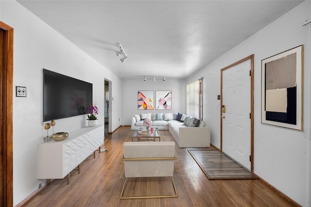 living room featuring hardwood / wood-style flooring and track lighting