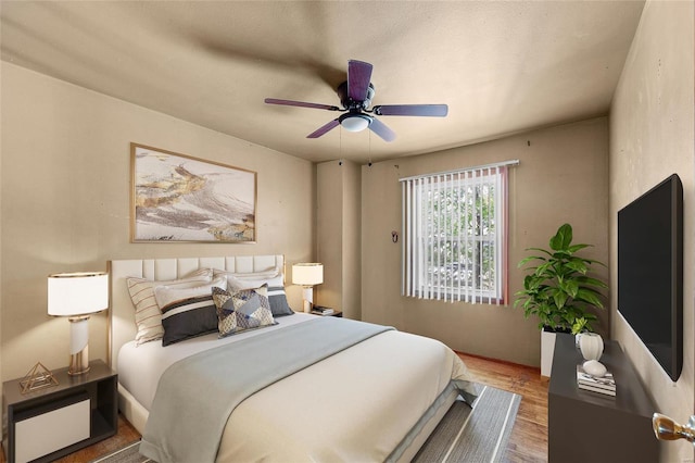 bedroom with ceiling fan and hardwood / wood-style floors