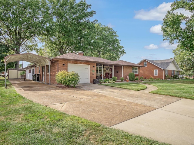 view of front of property featuring a front yard, a carport, and a garage