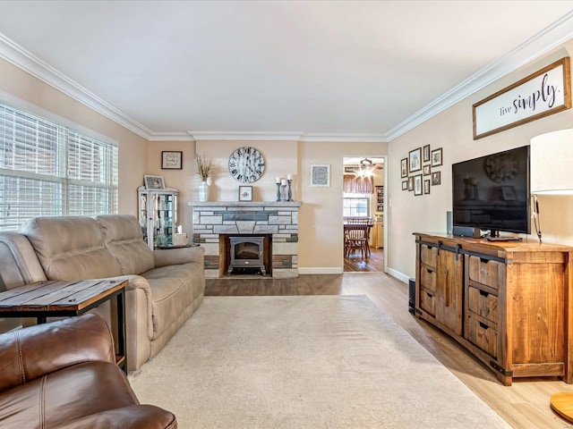 living room with ornamental molding, light hardwood / wood-style floors, and ceiling fan