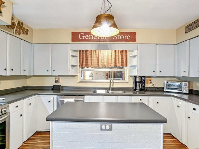 kitchen with white cabinetry, wood-type flooring, sink, and a kitchen island