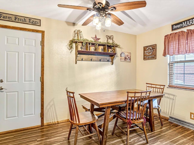 dining space with dark wood-type flooring and ceiling fan