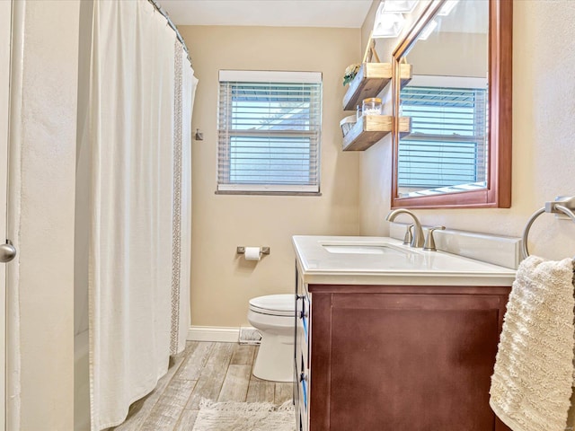 bathroom featuring hardwood / wood-style floors, vanity, toilet, and a shower with curtain