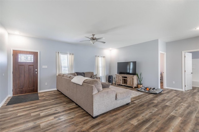 living room with ceiling fan and dark hardwood / wood-style flooring