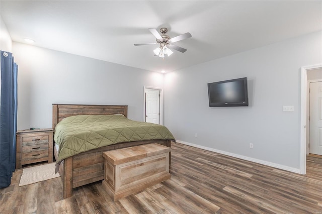 bedroom with ceiling fan and dark hardwood / wood-style flooring