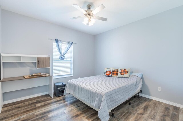 bedroom with dark wood-type flooring and ceiling fan