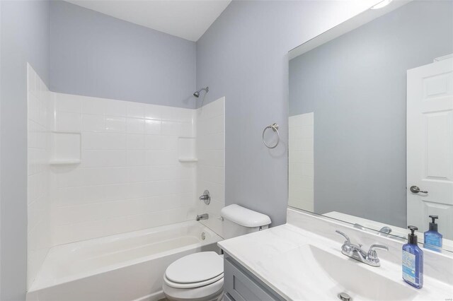 full bathroom featuring tub / shower combination, vanity, and toilet