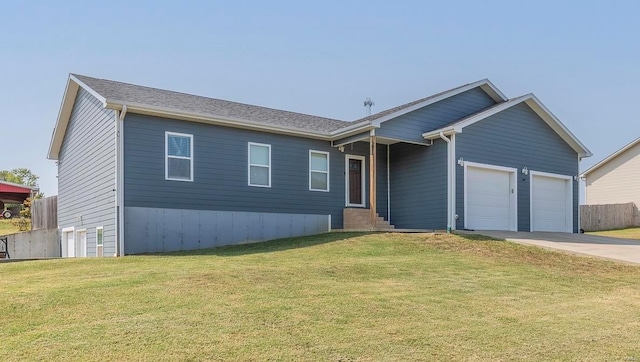 view of front of home with a garage and a front lawn