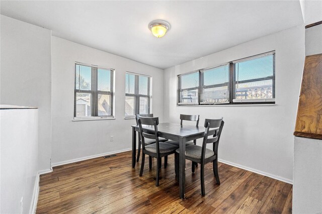 dining area with dark hardwood / wood-style flooring