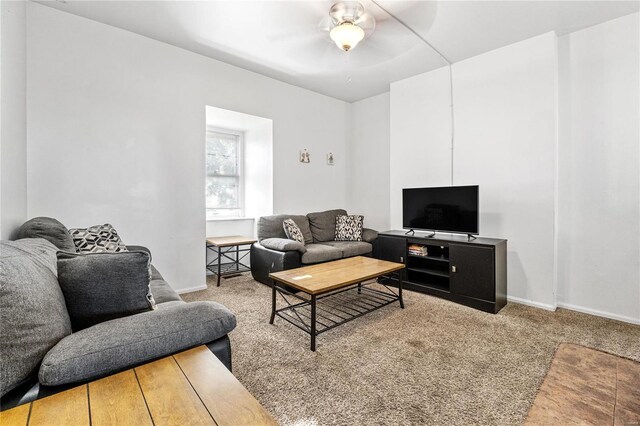 living room with ceiling fan and carpet flooring