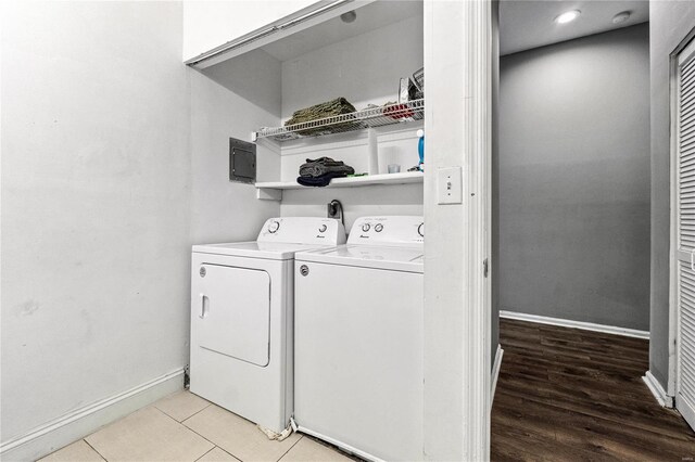 laundry area featuring light wood-type flooring and washing machine and clothes dryer