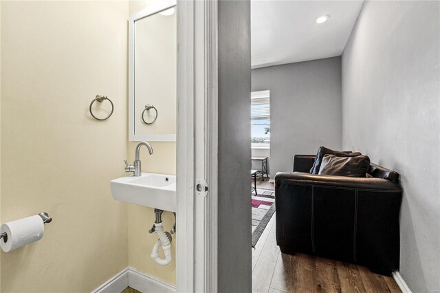 bathroom featuring wood-type flooring and sink