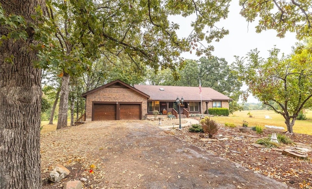 ranch-style home with a garage and a porch