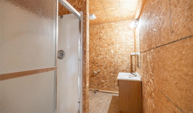 bathroom with vanity and a shower with door