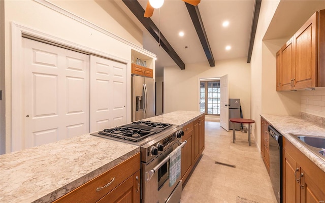 kitchen with appliances with stainless steel finishes, tasteful backsplash, beam ceiling, and ceiling fan