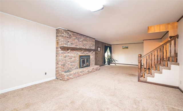 unfurnished living room featuring crown molding, a brick fireplace, and carpet