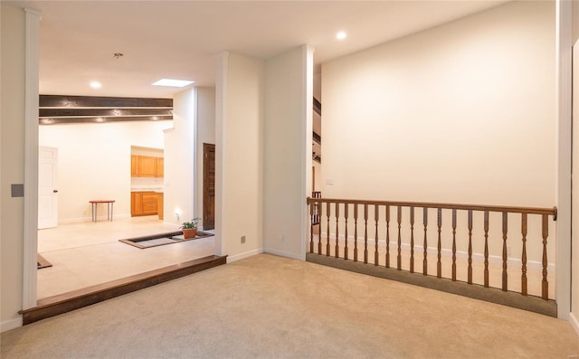 carpeted empty room with baseboards and recessed lighting